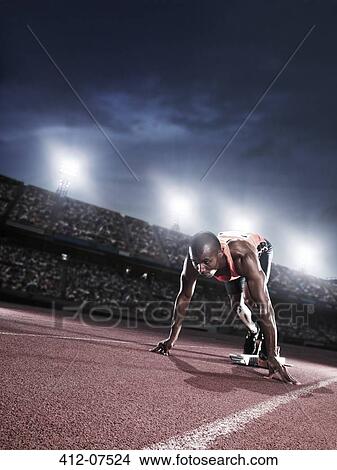Runner poised at starting line on track View Large Photo Image Picture - Runner poised at starting line on track. Fotosearch