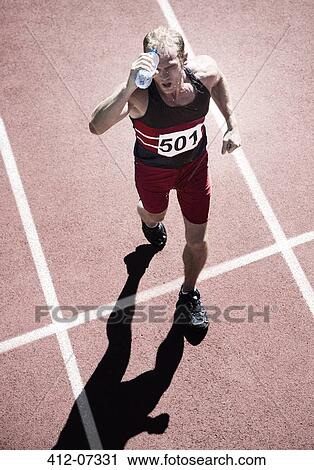 Runner pouring water overhead on track View Large Photo Image Stock Image - Runner pouring water overhead on track. Fotosearch