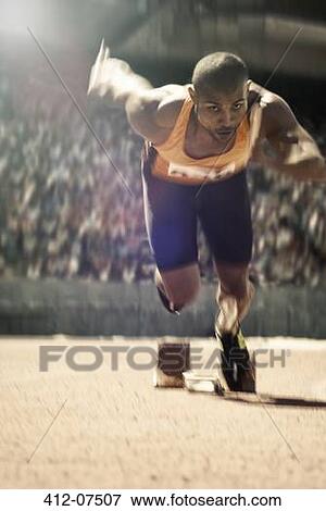 Runner taking off from starting block on track View Large Photo Image Stock Photo - Runner taking off from starting block on track. Fotosearch