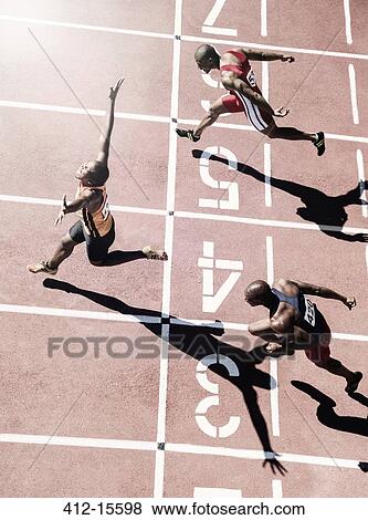 Runners crossing finish line View Large Photo Image Stock Photo - Runners crossing finish line. Fotosearch