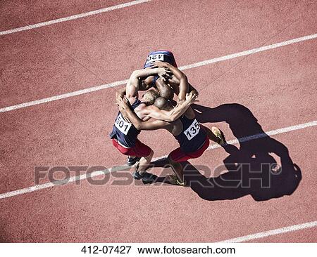 Runners huddled on track View Large Photo Image Stock Photo - Runners huddled on track. Fotosearch