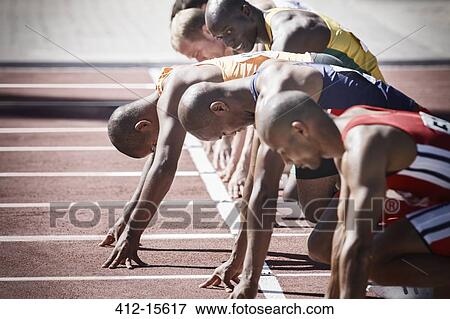 Runners preparing at starting line View Large Photo Image Stock Photo - Runners preparing at starting line. Fotosearch