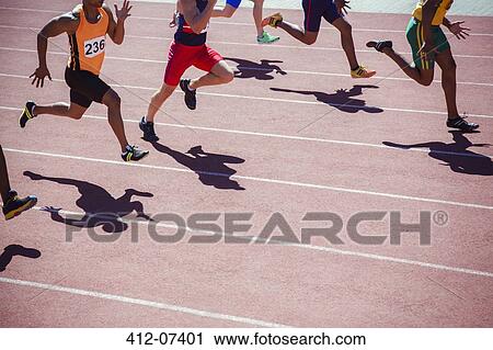 Stock Image - Runners racing on track. Fotosearch