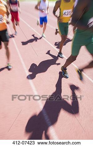 Runners racing on track View Large Photo Image Stock Image - Runners racing on track. Fotosearch