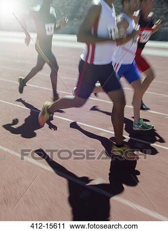Runners racing on track View Large Photo Image Stock Image - Runners racing on track. Fotosearch