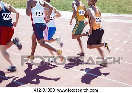 Runners racing on track View Large Photo Image Stock Photo - Runners racing on track. Fotosearch