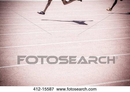 Runners racing on track View Large Photo Image Stock Photo - Runners racing on track. Fotosearch
