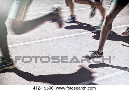 Stock Photograph - Runners racing on track. Fotosearch