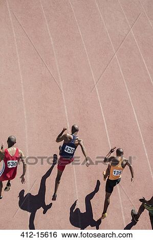Runners racing on track View Large Photo Image Stock Photograph - Runners racing on track. Fotosearch