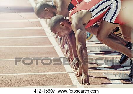 Runners ready at starting block View Large Photo Image Stock Photo - Runners ready at starting block. Fotosearch