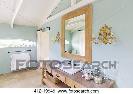 Stock Photography - Sink and mirror in rustic bathroom. Fotosearch