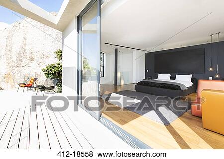 Sliding glass door onto bedroom in modern house View Large Photo Image Stock Photo - Sliding glass door onto bedroom in modern house. Fotosearch