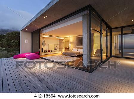 Sliding glass doors onto bedroom of modern house View Large Photo Image Picture - Sliding glass doors onto bedroom of modern house. Fotosearch