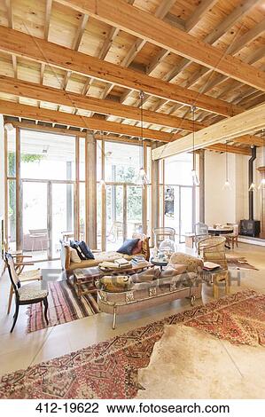Stock Image - Sofas and coffee table in rustic living room. Fotosearch