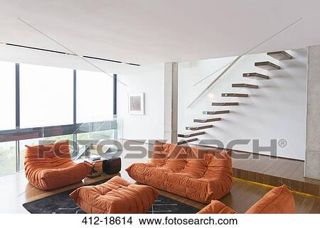 Sofas and staircase in modern living room View Large Photo Image Picture - Sofas and staircase in modern living room. Fotosearch