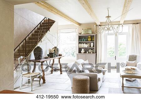 Stock Image - Sofas and staircase in modern living room. Fotosearch