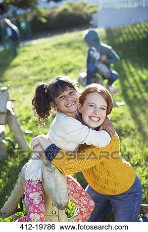 Student and teacher hugging outdoors View Large Photo Image Stock Photograph - Student and teacher hugging outdoors. Fotosearch