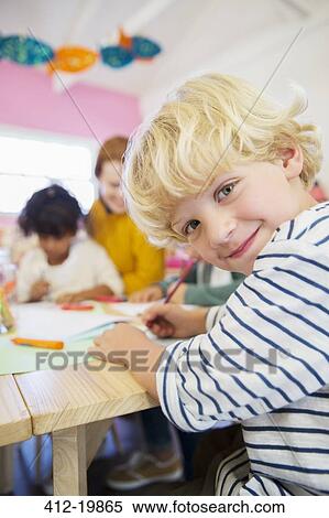 Stock Photography - Student drawing in classroom. Fotosearch
