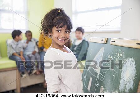 Student drawing on chalkboard in classroom View Large Photo Image Picture - Student drawing on chalkboard in classroom. Fotosearch