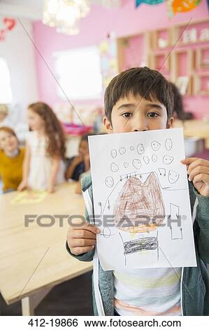Student showing drawing in classroom View Large Photo Image Stock Photograph - Student showing drawing in classroom. Fotosearch