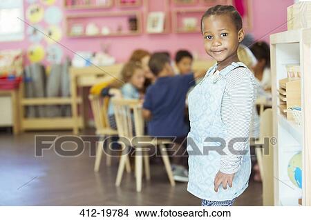 Picture - Student smiling in classroom. Fotosearch