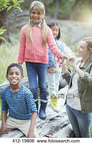 Students and teacher climbing on log View Large Photo Image Stock Photograph - Students and teacher climbing on log. Fotosearch