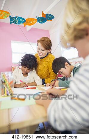 Students and teacher drawing in classroom View Large Photo Image Stock Image - Students and teacher drawing in classroom. Fotosearch