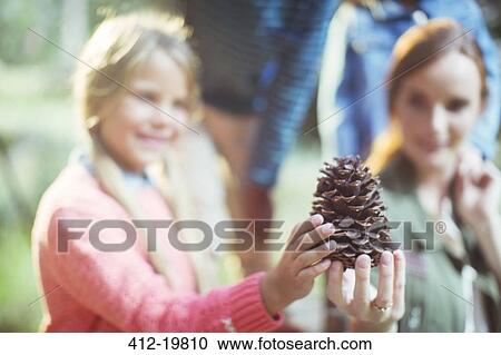 Students and teacher holding pine cone in forest View Large Photo Image Stock Image - Students and teacher holding pine cone in forest. Fotosearch