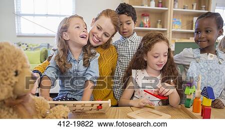 Students and teacher playing in classroom View Large Photo Image Stock Image - Students and teacher playing in classroom. Fotosearch
