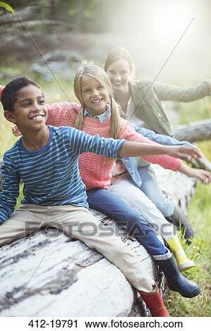 Students and teacher sitting on log in forest View Large Photo Image Stock Image - Students and teacher sitting on log in forest. Fotosearch