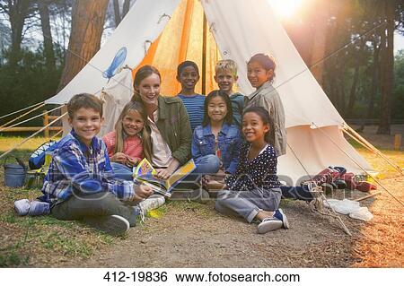 Students and teacher smiling at campsite View Large Photo Image Stock Photograph - Students and teacher smiling at campsite. Fotosearch