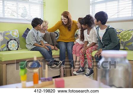Students and teacher talking in classroom View Large Photo Image Stock Image - Students and teacher talking in classroom. Fotosearch