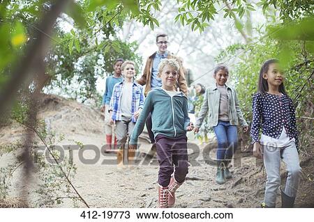 Students and teacher walking in forest View Large Photo Image Stock Image - Students and teacher walking in forest. Fotosearch