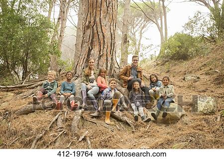 Students and teachers smiling in forest View Large Photo Image Picture - Students and teachers smiling in forest. Fotosearch