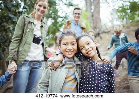 Students and teachers smiling in forest View Large Photo Image Picture - Students and teachers smiling in forest. Fotosearch