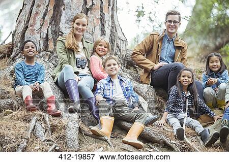 Stock Photo - Students and teachers smiling in forest. Fotosearch