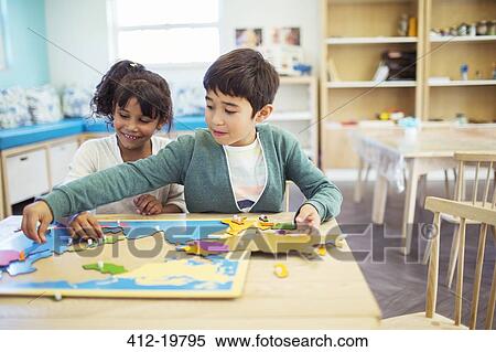 Students doing puzzle in classroom View Large Photo Image Stock Photography - Students doing puzzle in classroom. Fotosearch