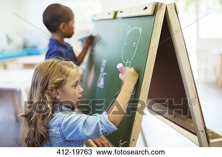 Students drawing on chalkboard in classroom View Large Photo Image Stock Image - Students drawing on chalkboard in classroom. Fotosearch