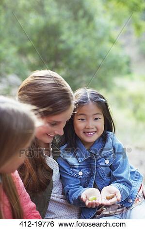 Teacher and student examining plants outdoors View Large Photo Image Stock Photograph - Teacher and student examining plants outdoors. Fotosearch