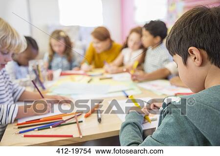 Teacher and students drawing in classroom View Large Photo Image Picture - Teacher and students drawing in classroom. Fotosearch