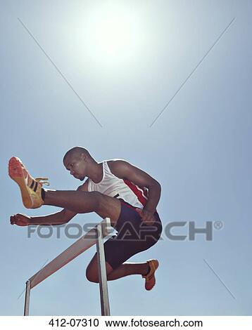 Track and field athlete clearing hurdle View Large Photo Image Stock Image - Track and field athlete clearing hurdle. Fotosearch