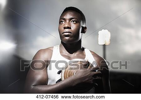 Track and field athlete holding discus View Large Photo Image Stock Photograph - Track and field athlete holding discus. Fotosearch
