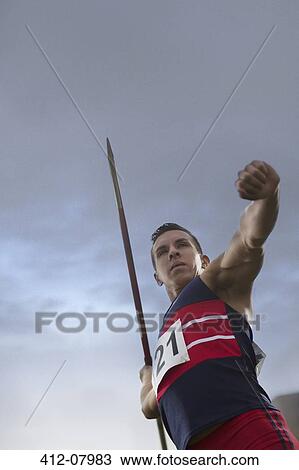 Track and field athlete holding javelin View Large Photo Image Stock Image - Track and field athlete holding javelin. Fotosearch