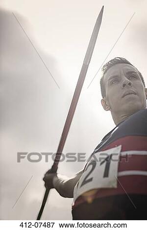 Stock Photo - Track and field athlete holding javelin. Fotosearch