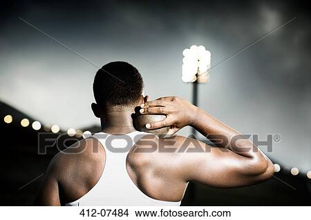 Track and field athlete holding shot put View Large Photo Image Picture - Track and field athlete holding shot put. Fotosearch