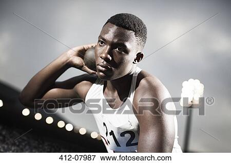 Stock Photo - Track and field athlete holding shot put. Fotosearch