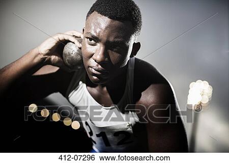 Track and field athlete holding shot put View Large Photo Image Stock Photograph - Track and field athlete holding shot put. Fotosearch
