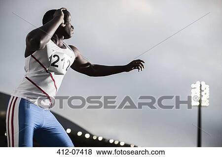 Stock Photo - Track and field athlete throwing shot put. Fotosearch