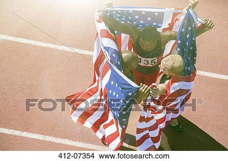 Track and field athletes holding American flags on track View Large Photo Image Picture - Track and field athletes holding American flags on track. Fotosearch