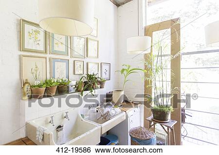 Wall hangings and lights over rustic kitchen sink View Large Photo Image Stock Photograph - Wall hangings and lights over rustic kitchen sink. Fotosearch
